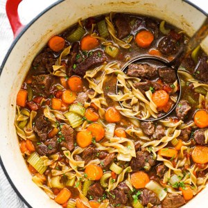 A pot of beef noodle soup in beef broth