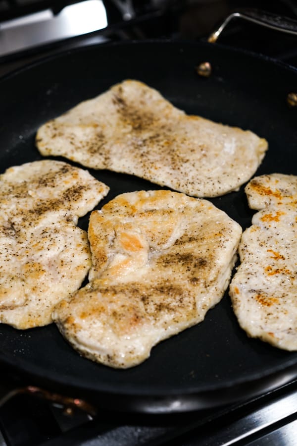 Pan searing seasoned chicken cutlets