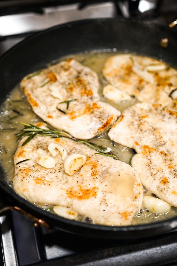 Garlic rosemary chicken and sauce in a skillet