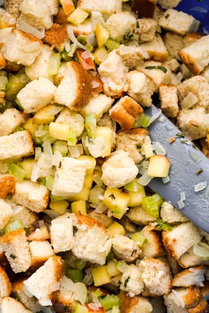 Tossing bread cubes in apple, celery and onion butter mixture