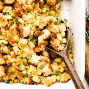 Scooping out some stuffing using a brown wooden spoon