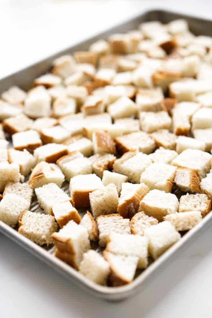 bread cubes on a large baking sheet