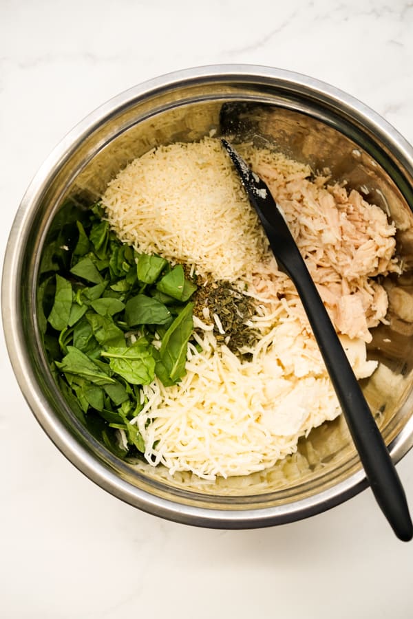 chicken, spinach, mozzarella cheese, parmesan, herbs in a large bowl