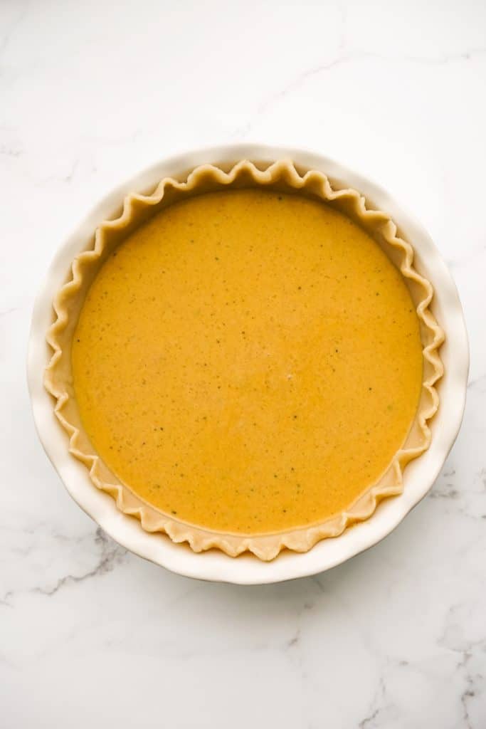 Unbaked pumpkin pie in a pie pan