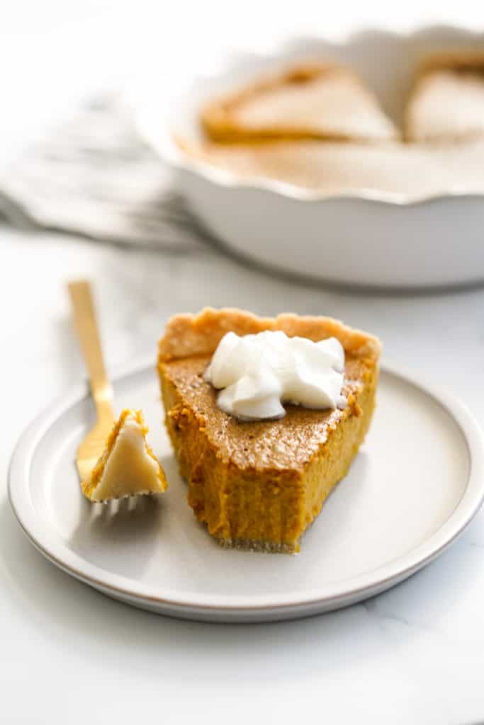 grabbing a chunk off a slice of pumpkin pie using a fork