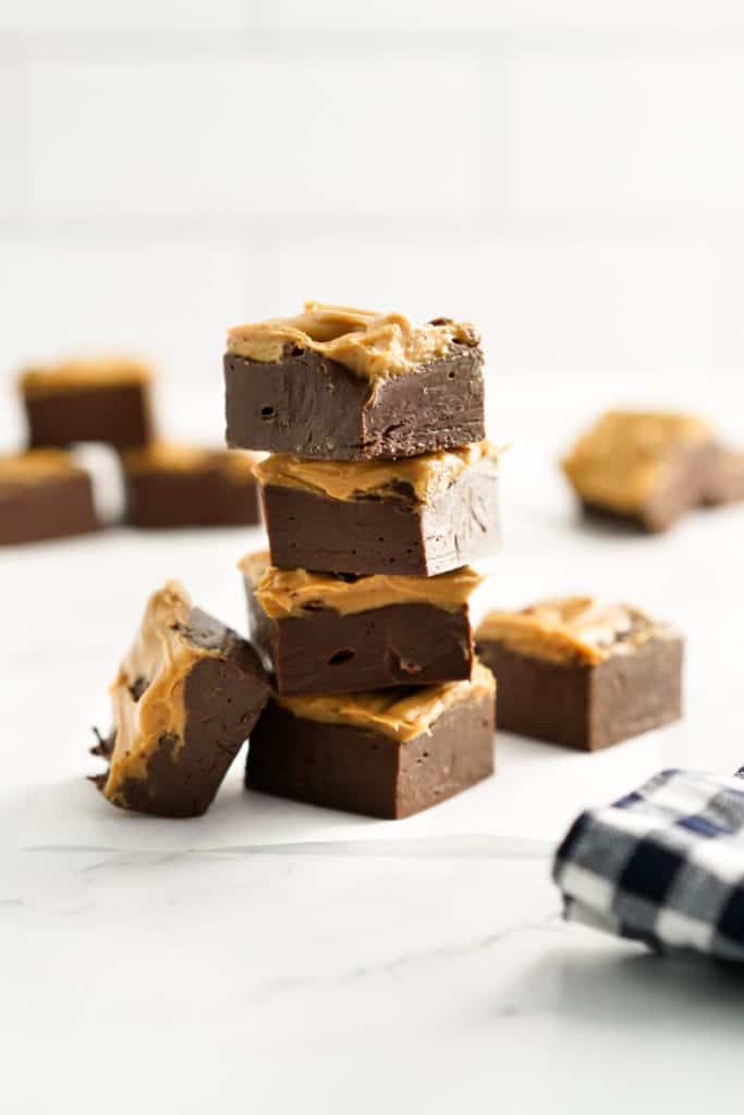 A stack of chocolate peanut butter fudge cut into squares