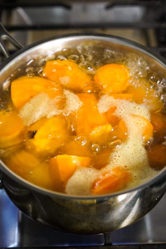 Boiling sweet potatoes in water in a large pot 