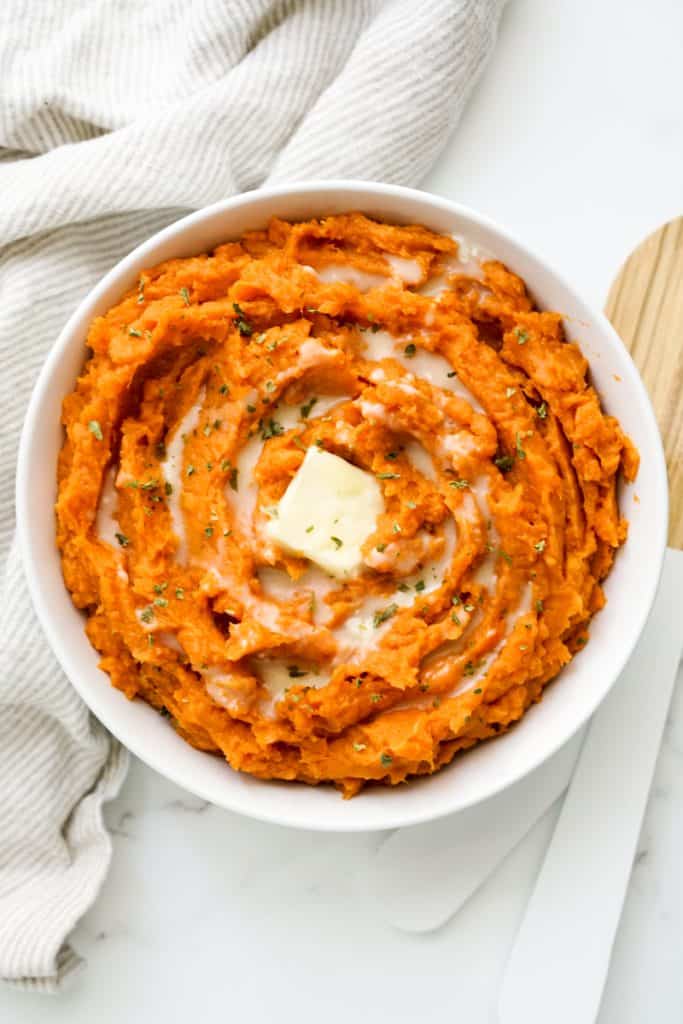 Top down view of a bowl of cinnamon brown sugar mashed sweet potatoes