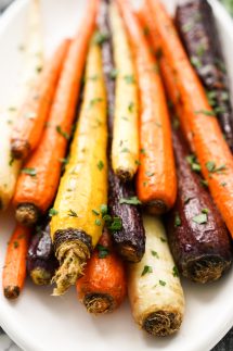 A plate piled high with colorful whole stalks of carrots
