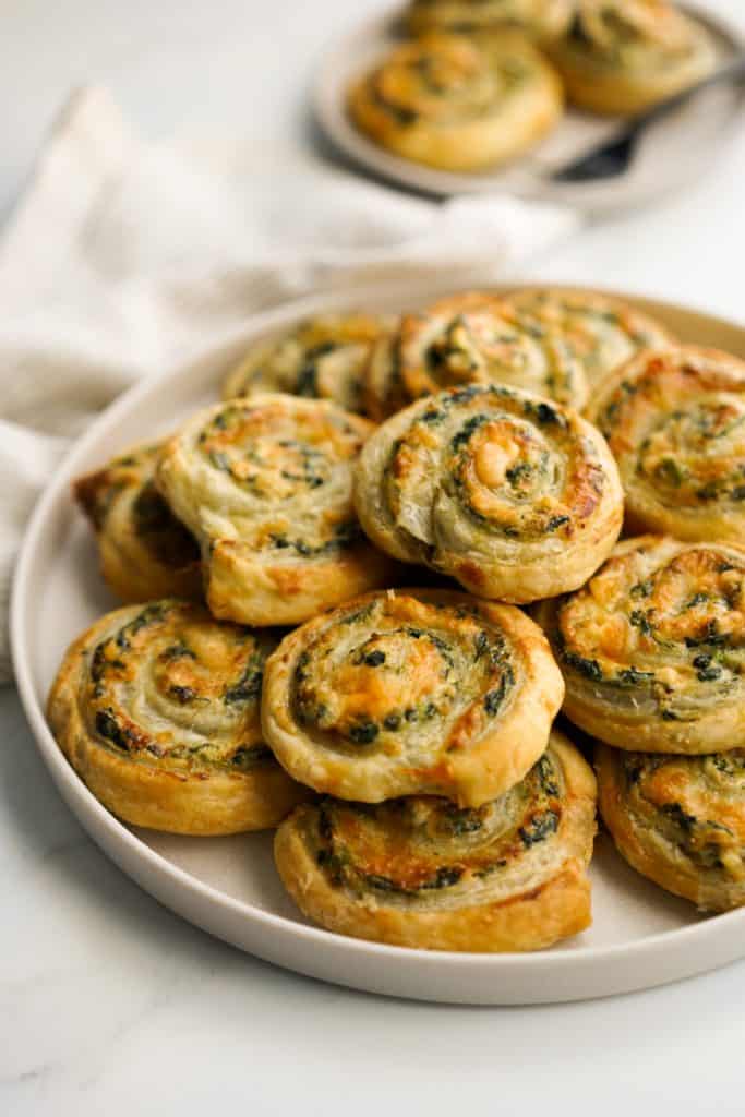 A plate of spinach pinwheels rolls in puff pastry
