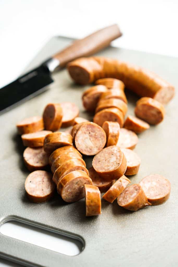 Sliced smoked sausage on cutting board