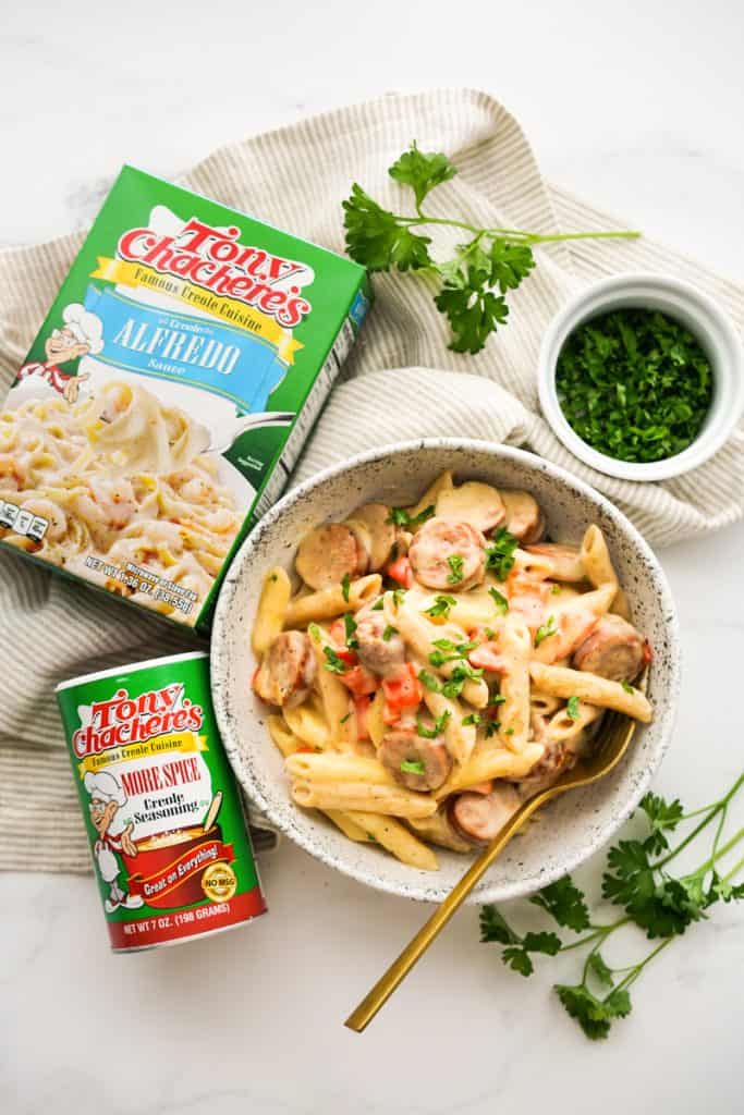 Top down view of a bowl of pasta with Tony Chachere's Cajun products