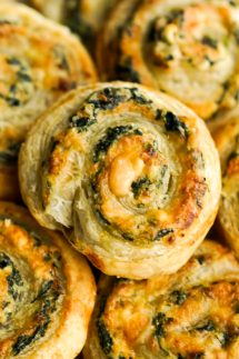 closeup of a puff pastry pinwheel stuffed with spinach and cheese