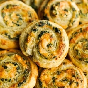 closeup of a puff pastry pinwheel stuffed with spinach and cheese