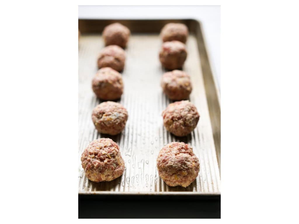 Rolled out sausage balls on a baking sheet