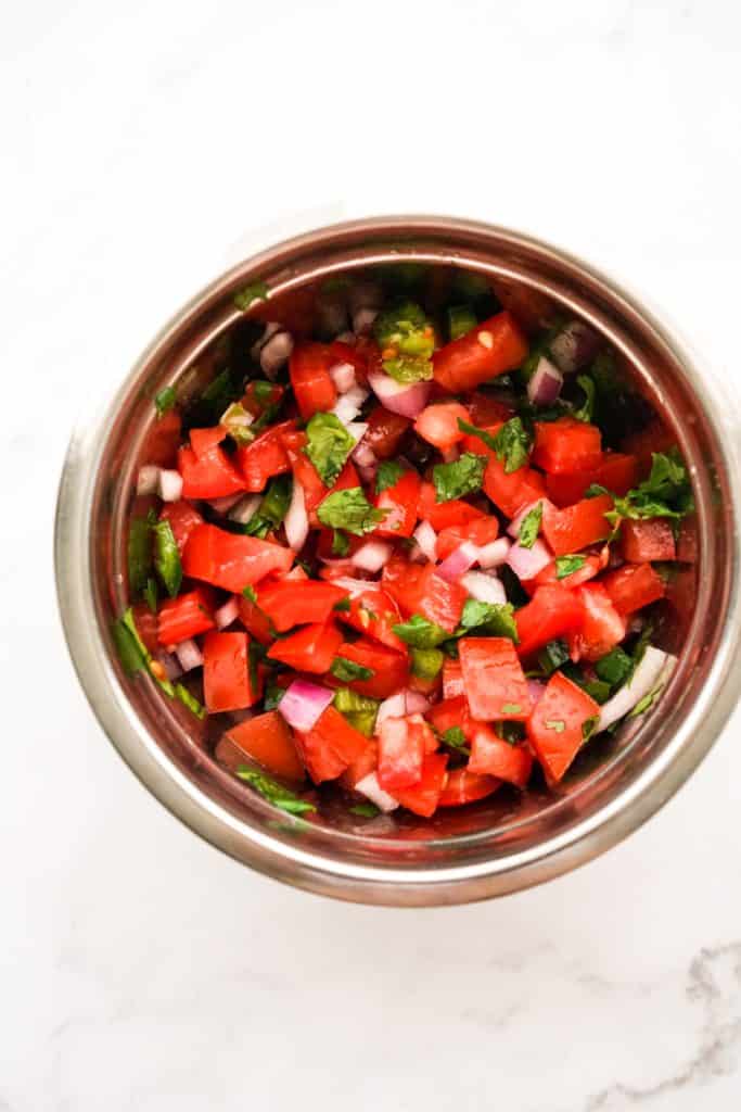 Pico de gallo in a mixing bowl