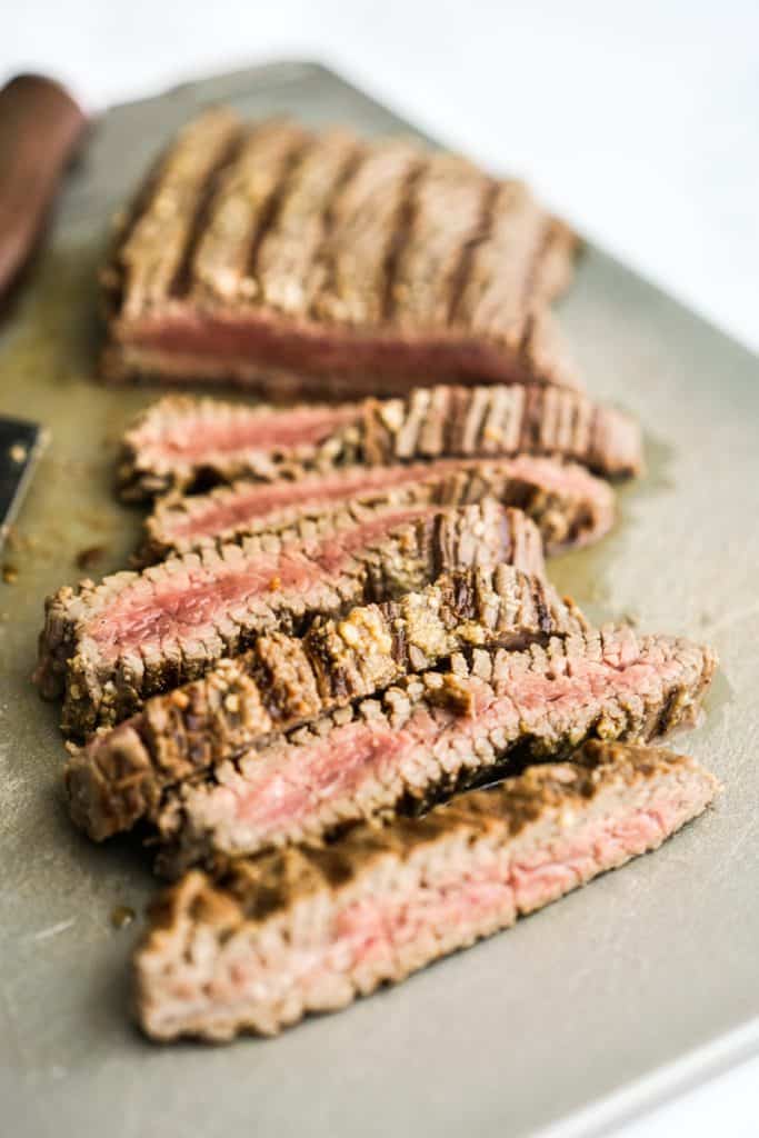 Steak sliced into thin strips on a cutting board
