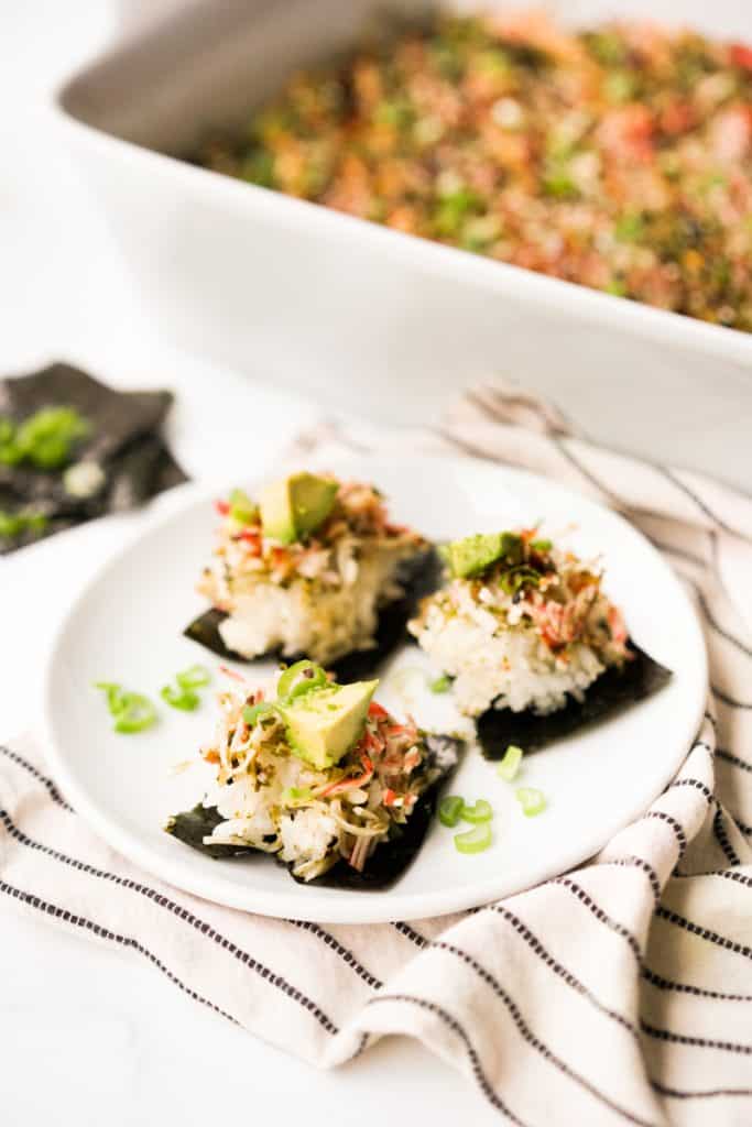 spoonfuls of sushi bake on smaller pieces of nori