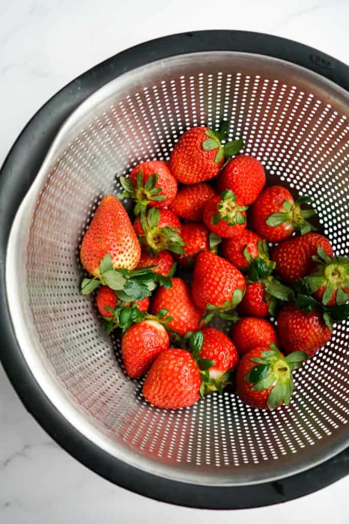 Fresh strawberries in a colander.