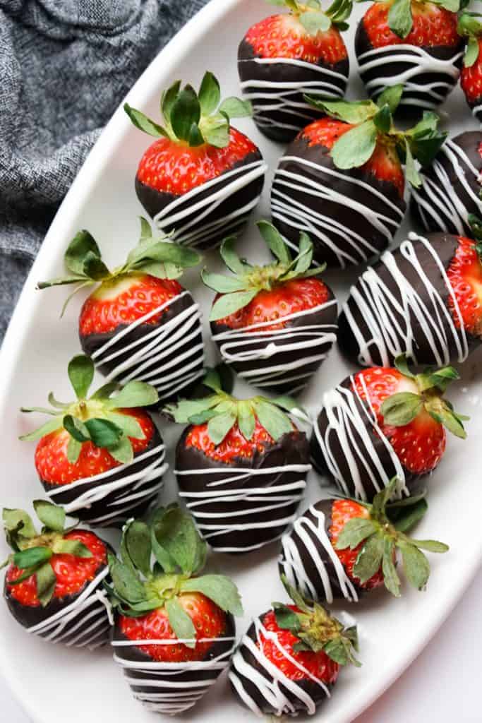 An oval plate of chocolate covered strawberries