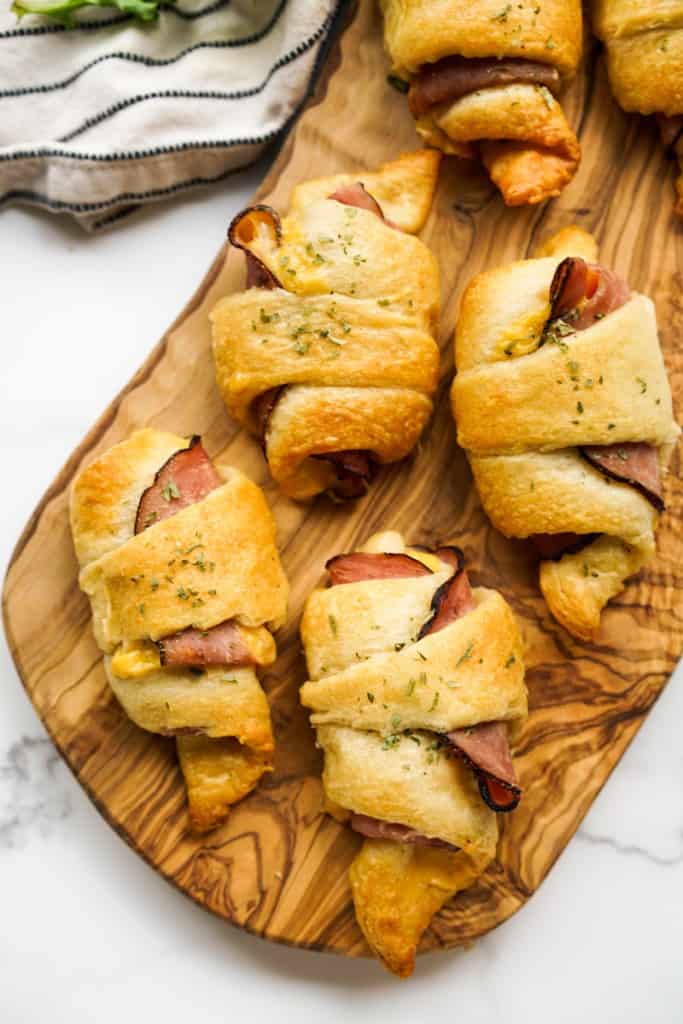 Ham and cheese rolled up in crescent rolls on a platter