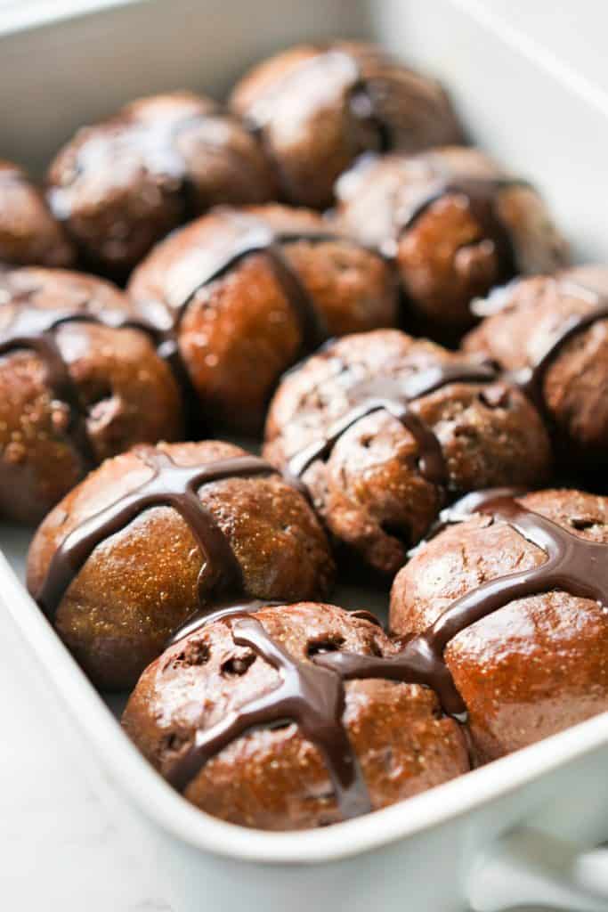 A dish full of chocolate hot cross buns