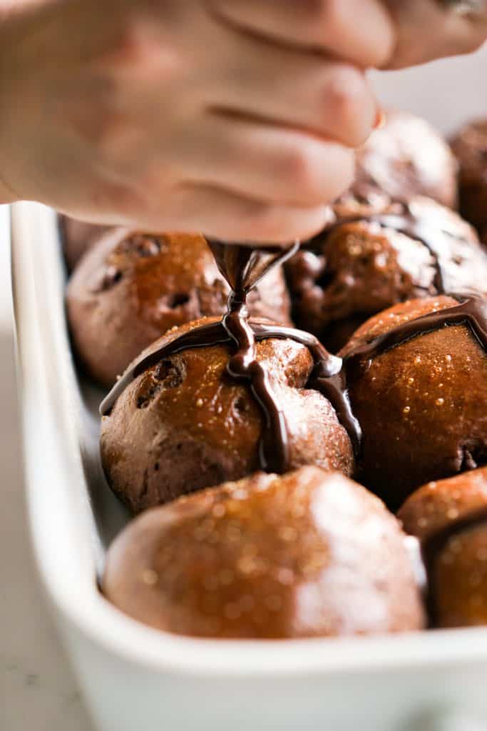 Drawing crosses on the chocolate hot cross buns