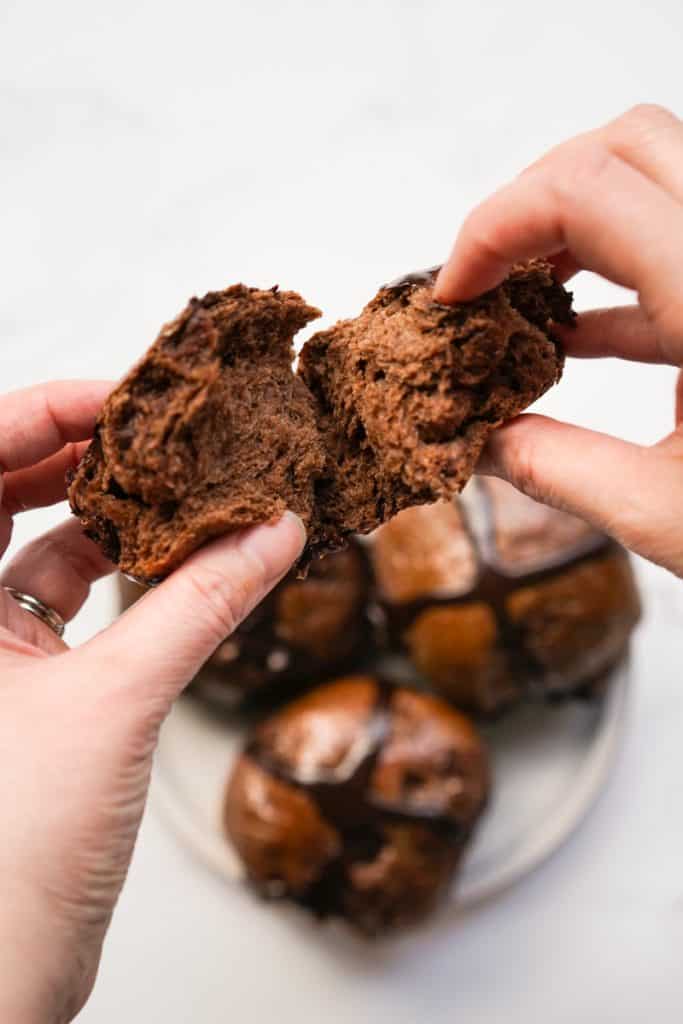 The soft and fluffy texture inside a chocolate hot cross bun