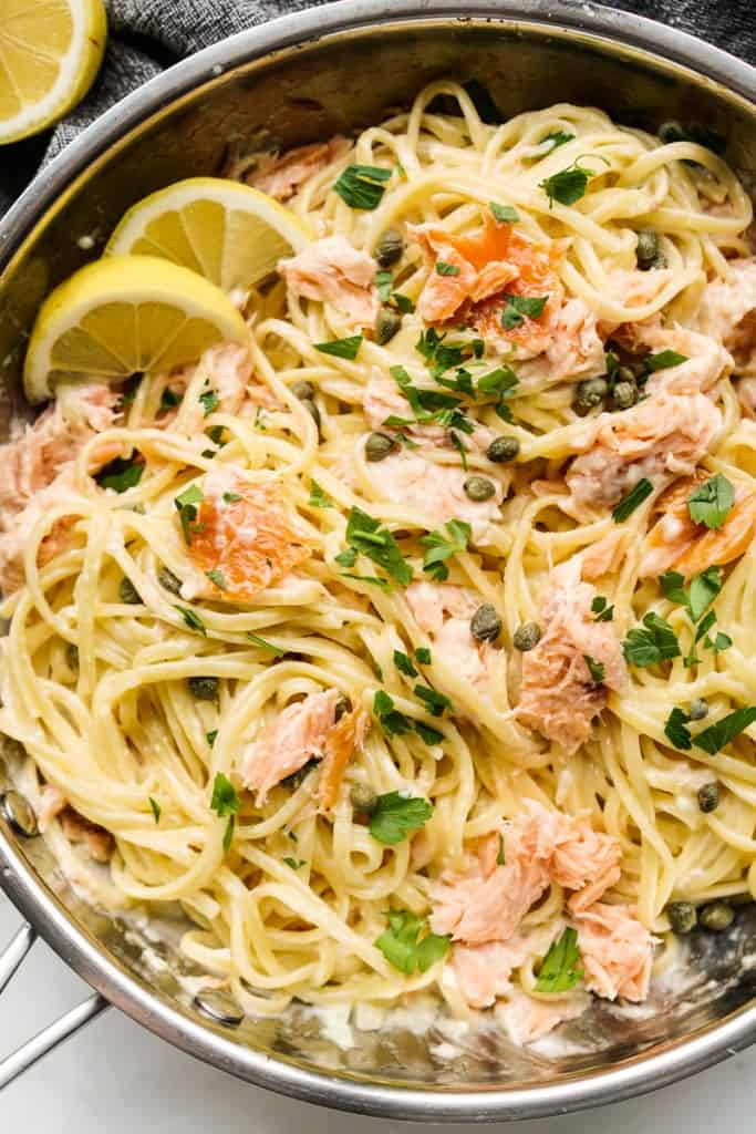 Closeup of linguini pasta with smoked salmon, lemons and capers