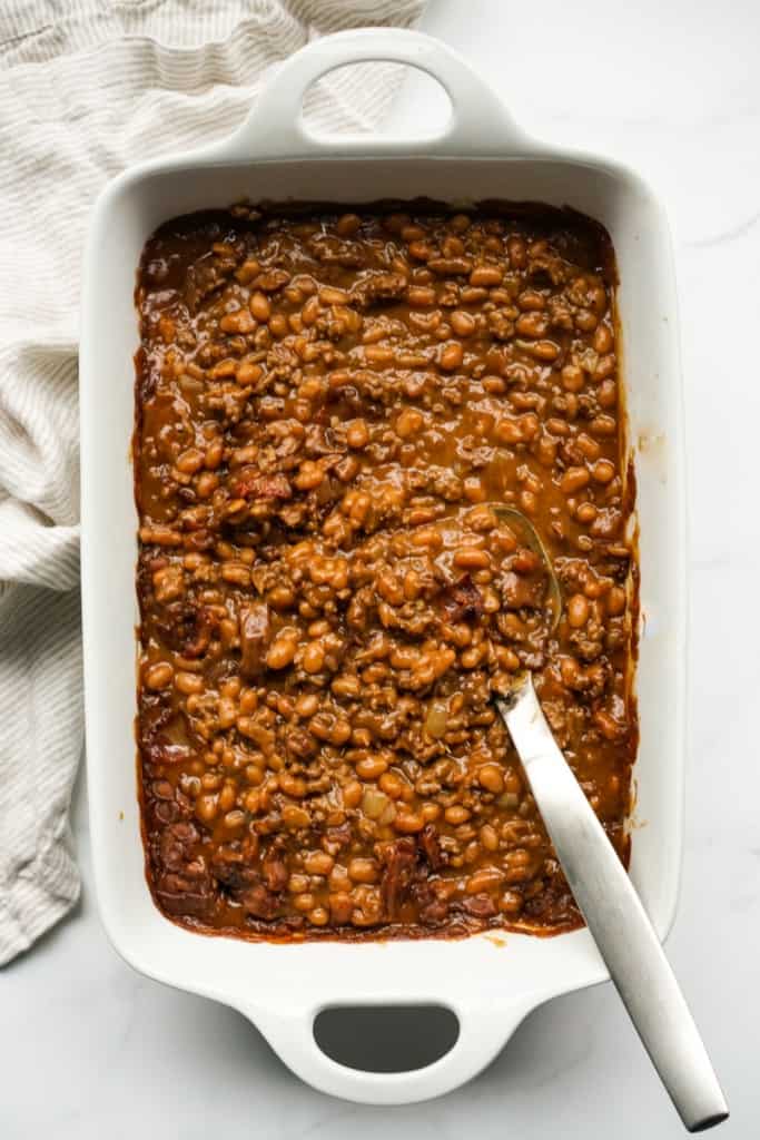 A casserole dish filled with bbq baked beans with ground beef