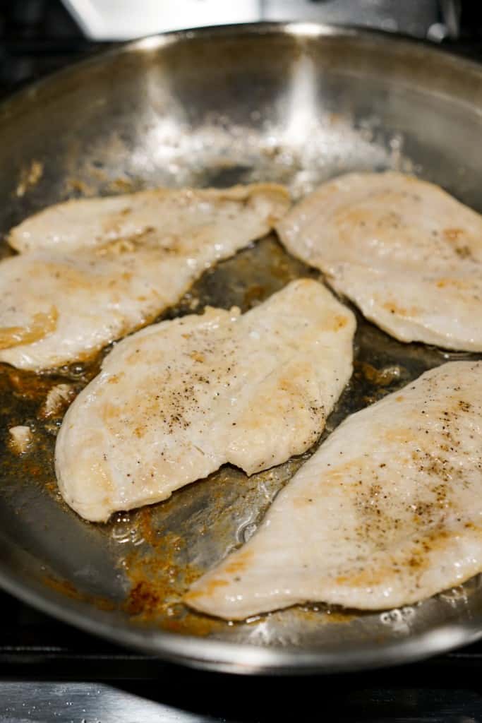 Searing chicken cutlet on a stainless steel skillet