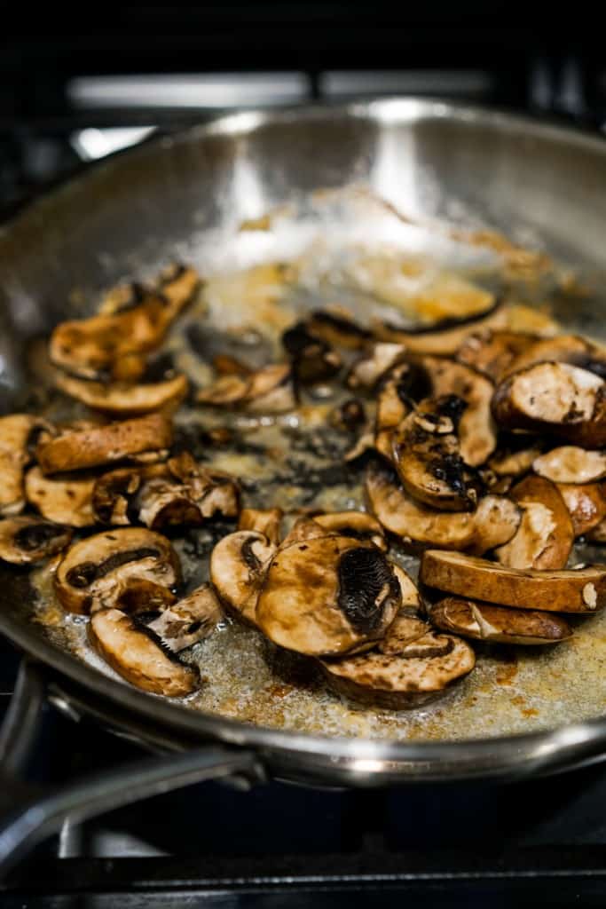 Searing sliced  mushrooms in skillet