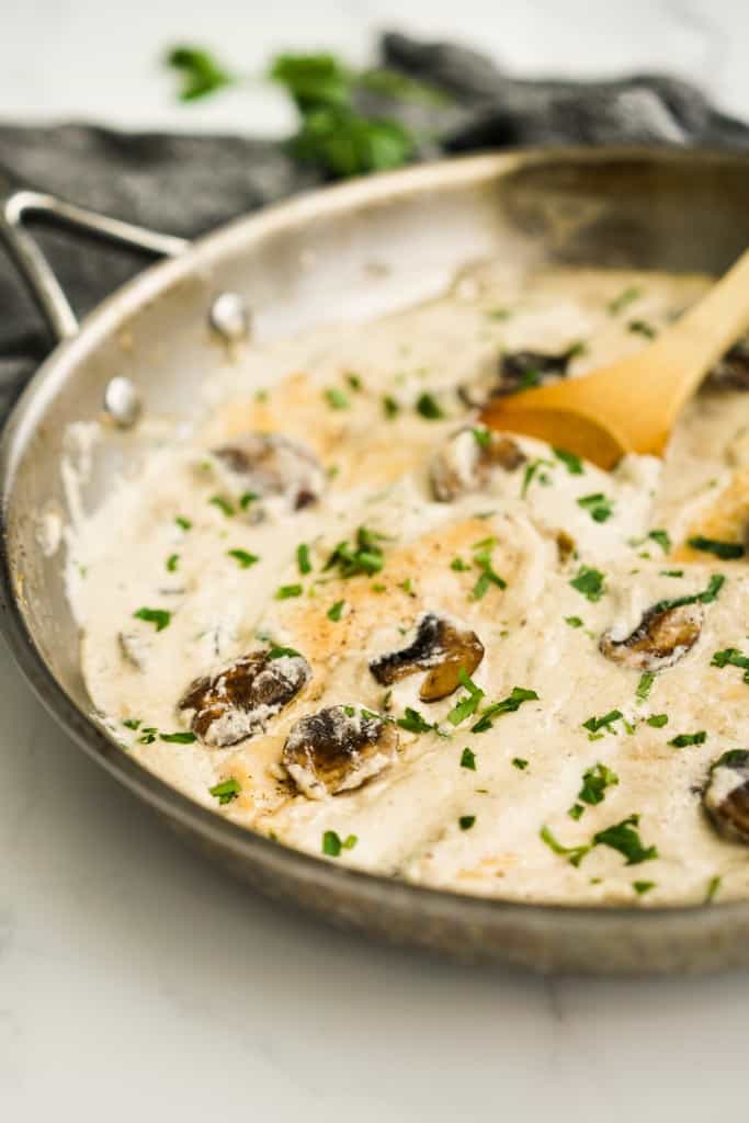 Skillet filled with chicken in creamy mushroom sauce