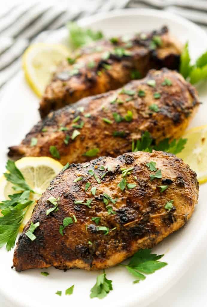 Pieces of chicken breast lined up on a platter