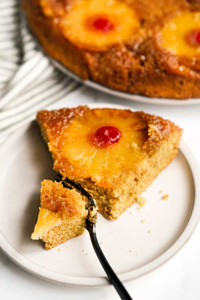 Cutting out a slice of pineapple upside down cake