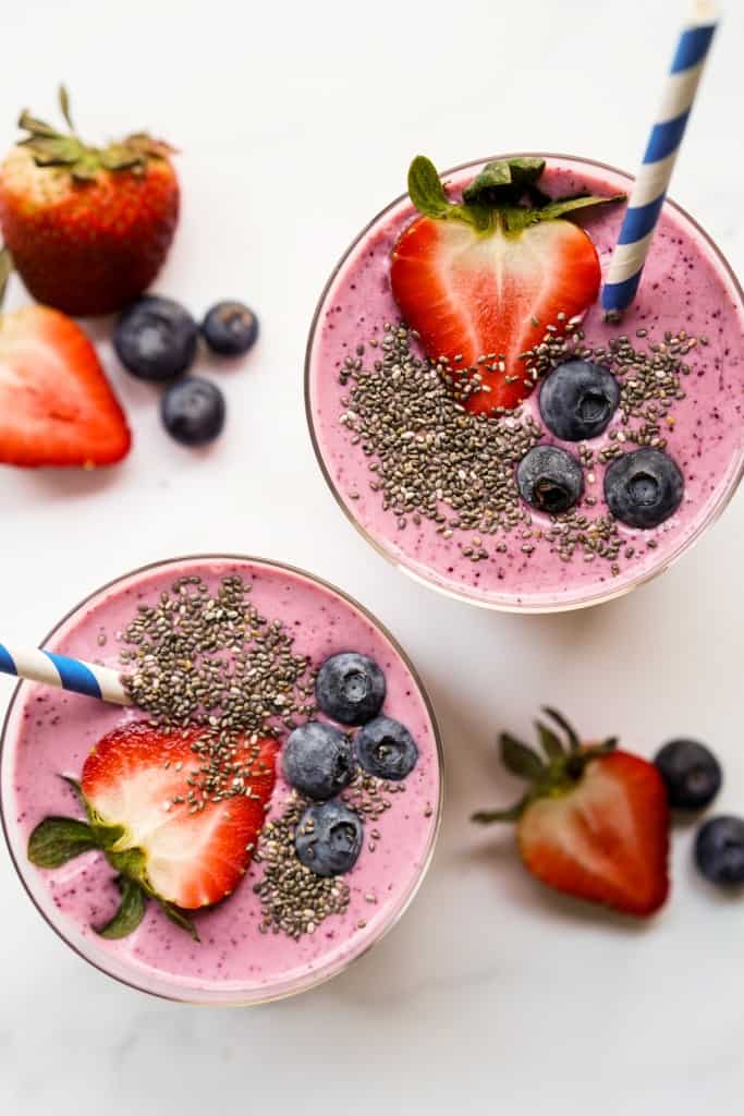 Top view of the top of two smoothie glass filled with fruits and chia seeds