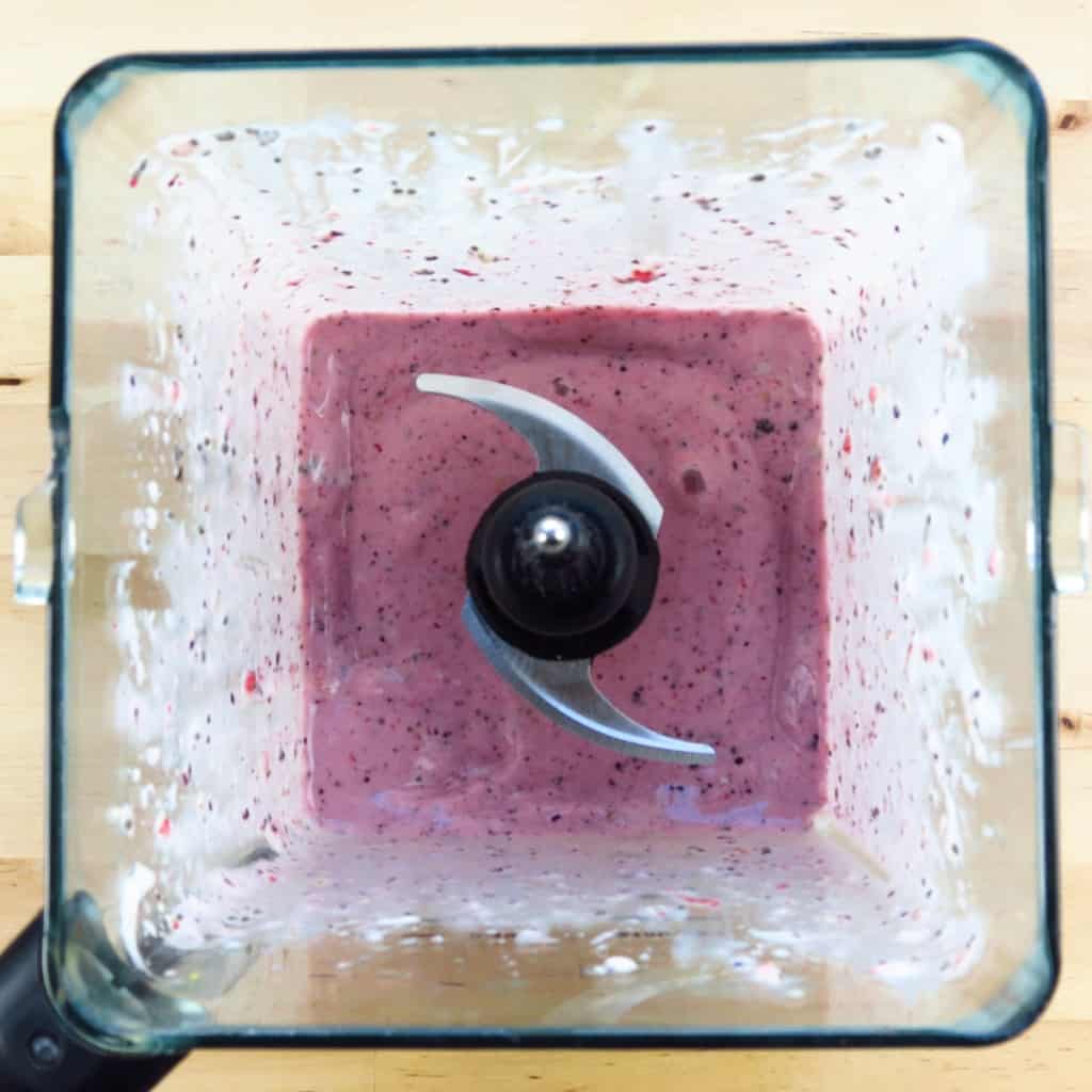Blended strawberry blueberry bananas smoothie in the blender.