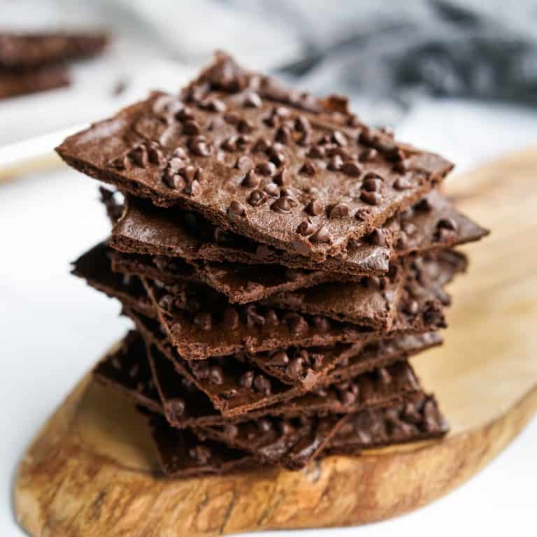 A stack of brownie brittle on a wooden serving platter