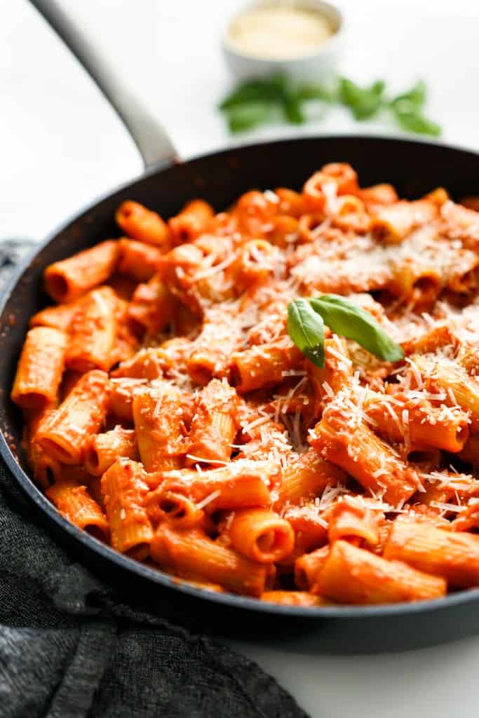 A skillet loaded with rigatoni tossed in thick vodka tomato sauce.