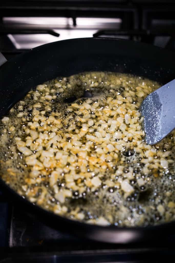 Cooking minced onions and garlic in skillet 