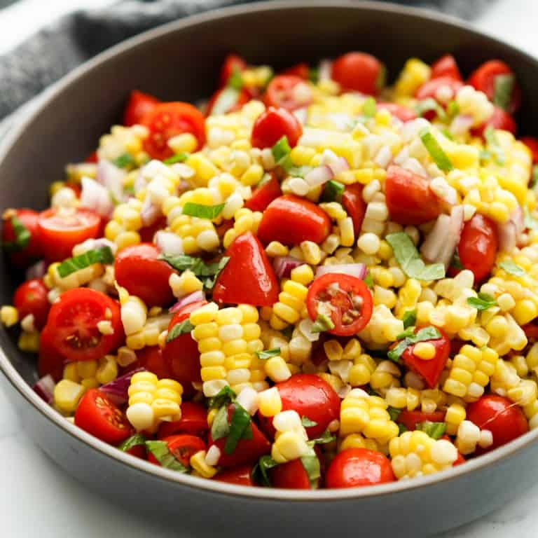 A bowl of fresh corn and tomato salad