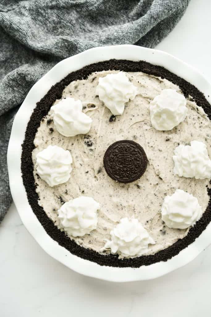 Top down view of an Oreo pie topped with whipped cream and an Oreo cookie