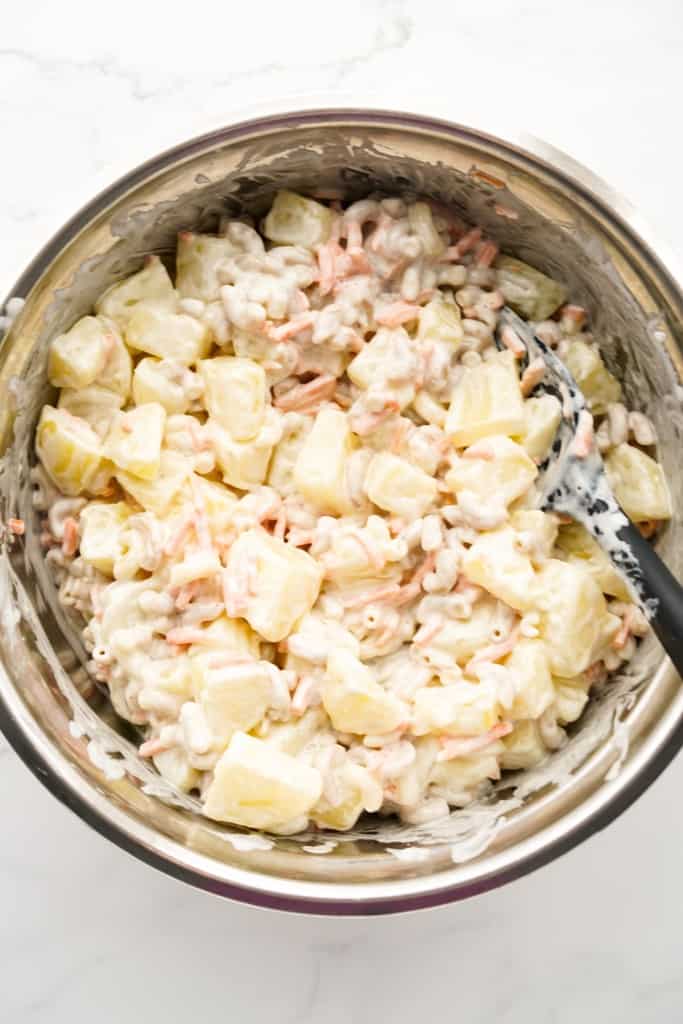 Cubed potatoes, macaroni pasta, shredded carrots coated in creamy dressing