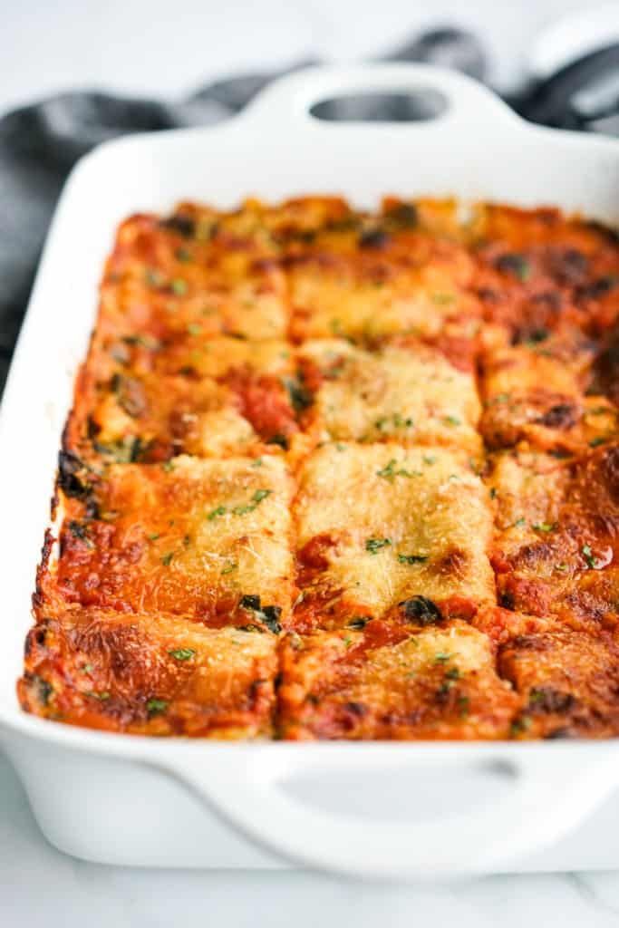A casserole filled with layers of spinach lasagna