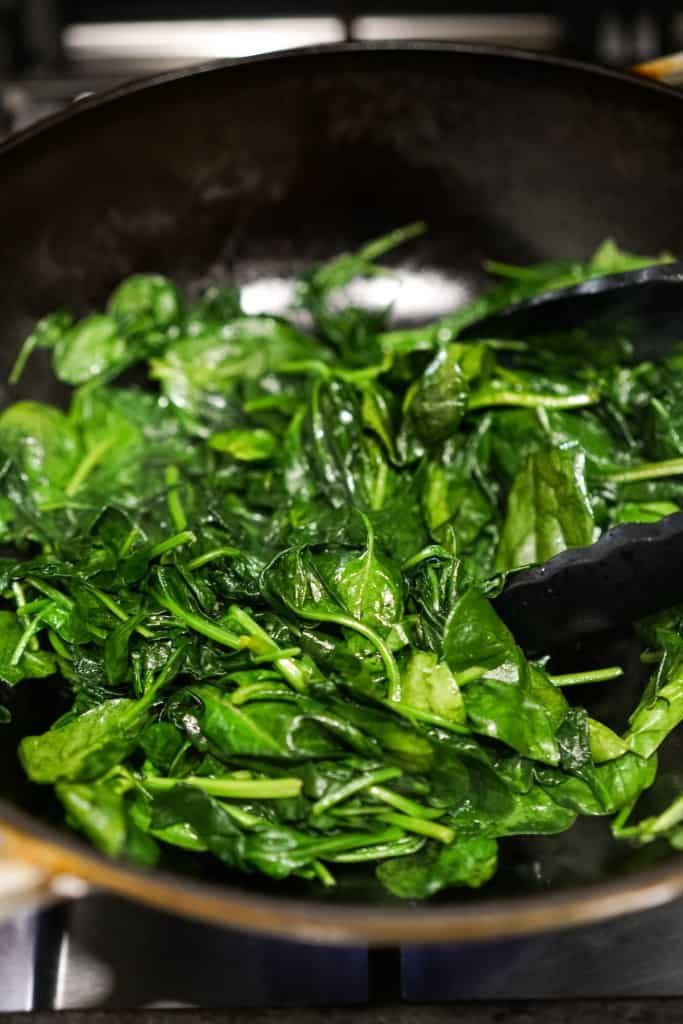 Sauteing spinach in a skillet