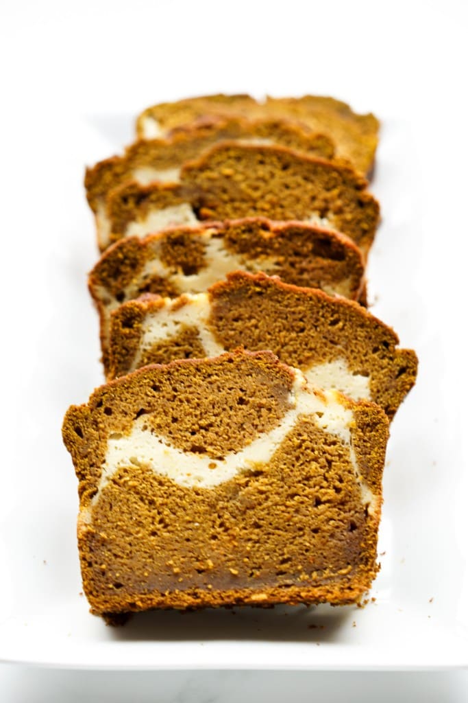 Slices of pumpkin cream cheese bread on a rectangular plate