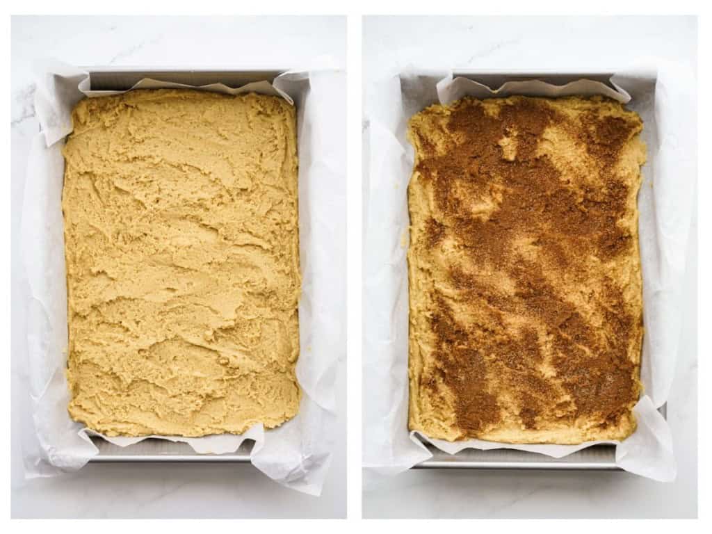 Unbaked Snickerdoodle dough spread out on a rectangular baking dish, then topped with cinnamon sugar dusting
