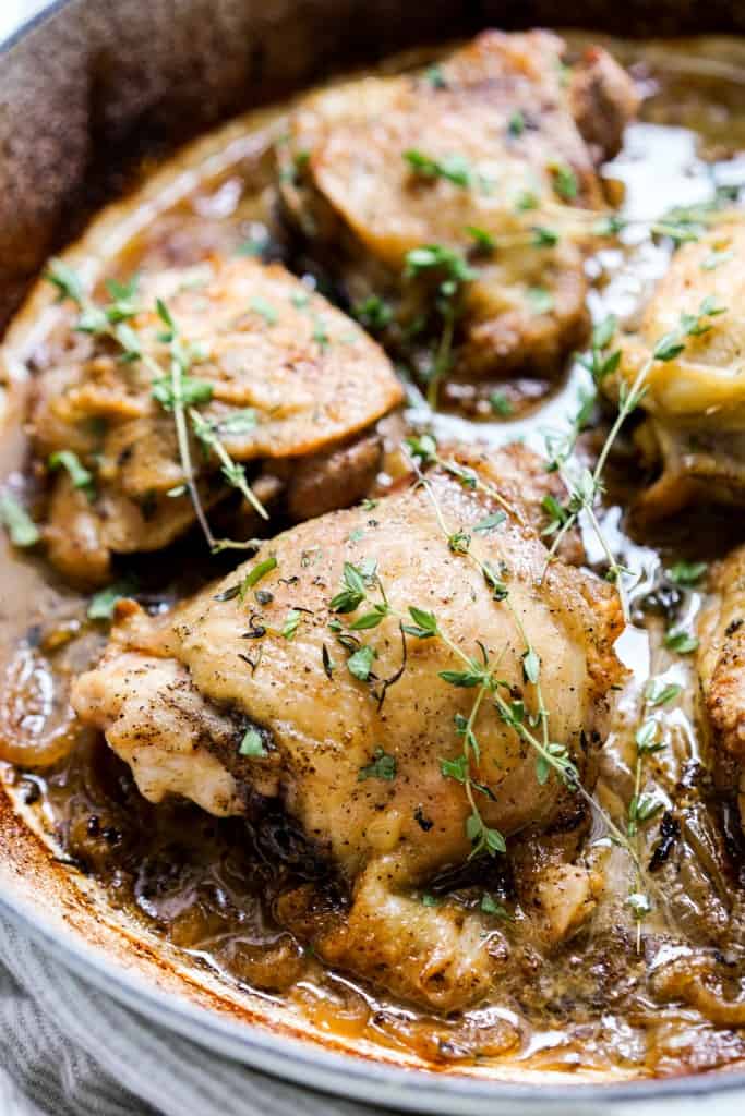 Skin-on chicken thighs topped with herbs