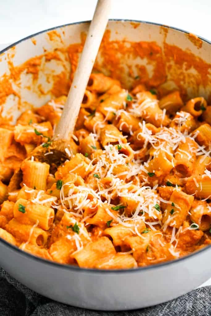 A big pot of pumpkin pasta tossed in creamy sauce topped with parmesan cheese