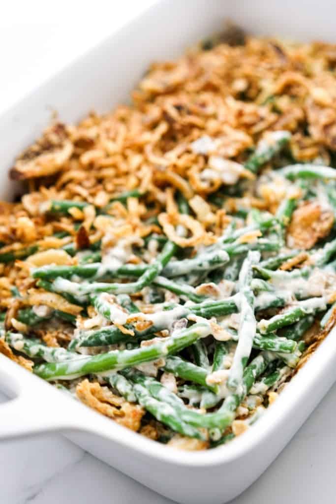 A casserole full of creamy green beans topped with fried onions